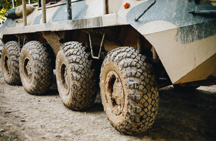Military vehicle with muddy tires